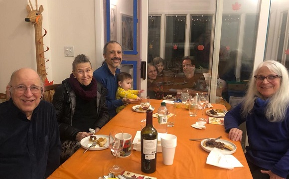 Families seated at tables on both sides of the divider